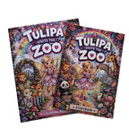 Two colorful children's coloring books titled 'Tulipa Visits the Zoo' are stacked on a light wood surface. The covers feature a whimsical fairy girl surrounded by zoo animals, flowers, and a rainbow, with one book labeled 'Coloring Book' and the other 'Storybook'.